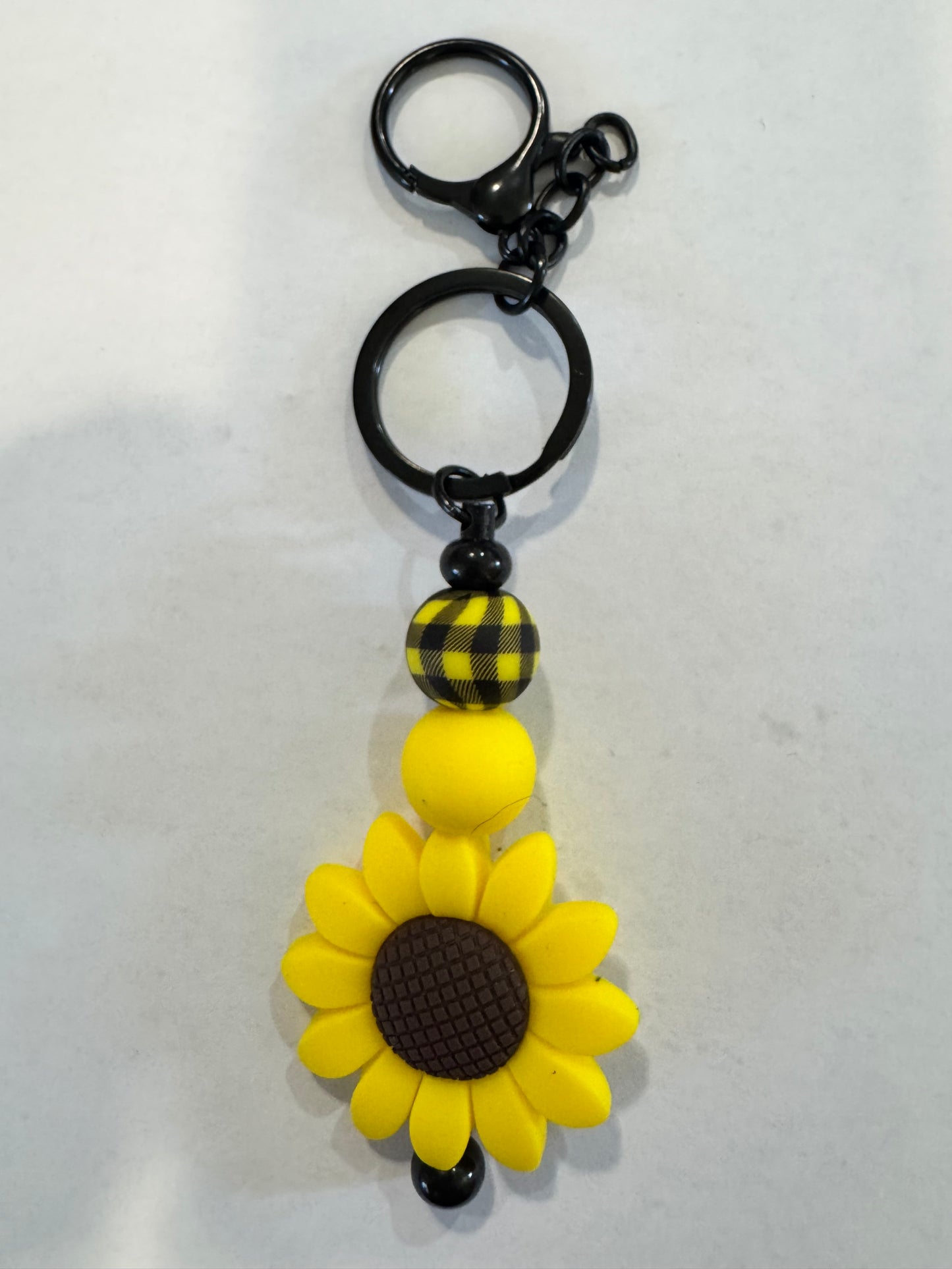 Keychain with sunflower design on a white background