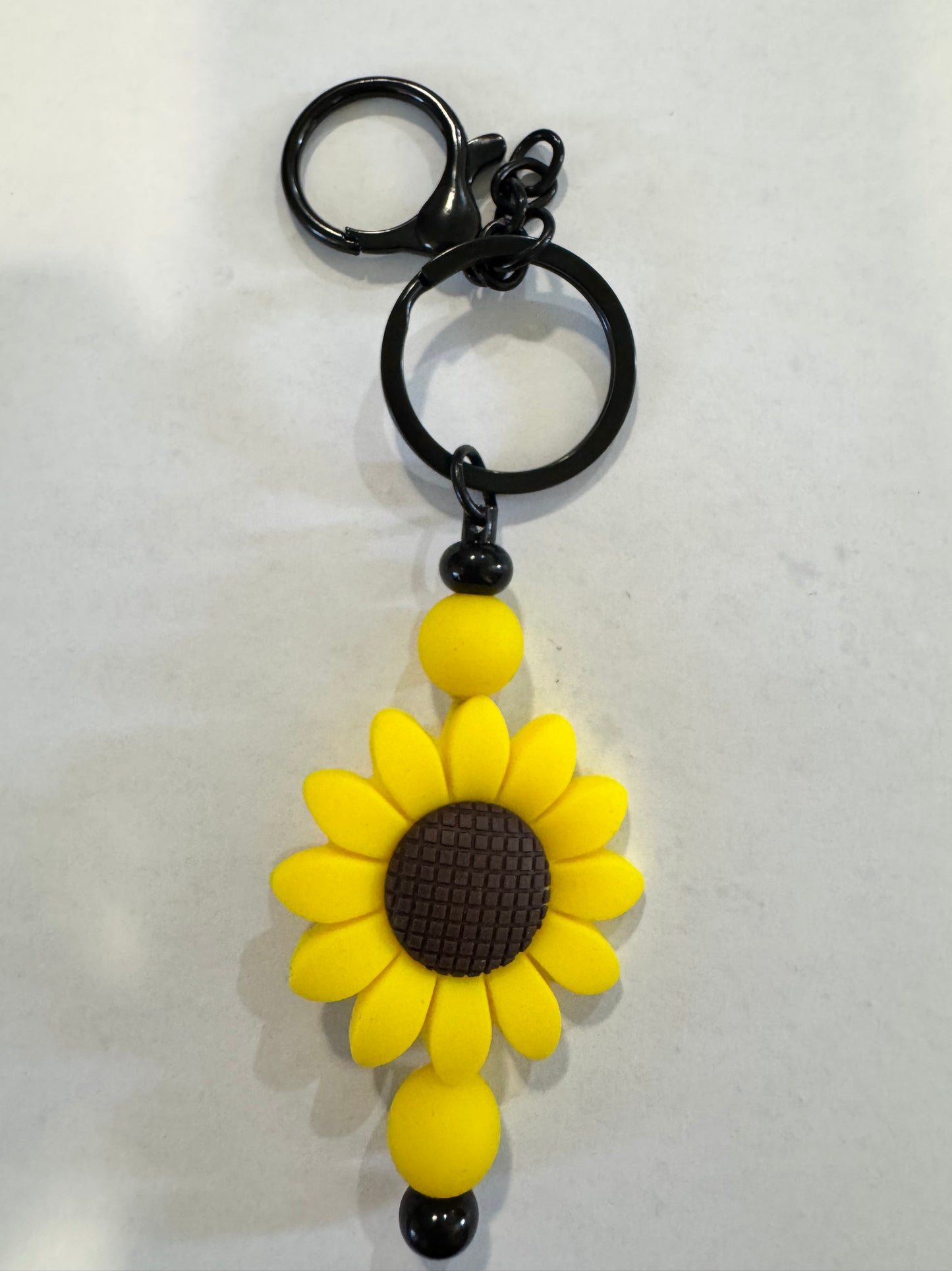 Sunflower-shaped keychain on a white background