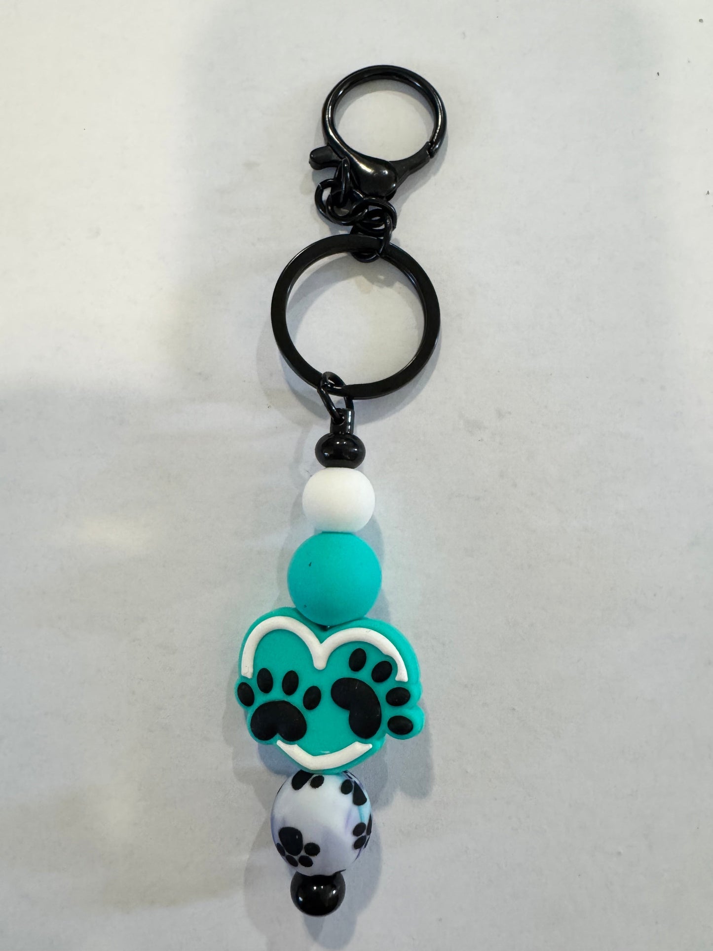 Keychain with paw print design on a white background