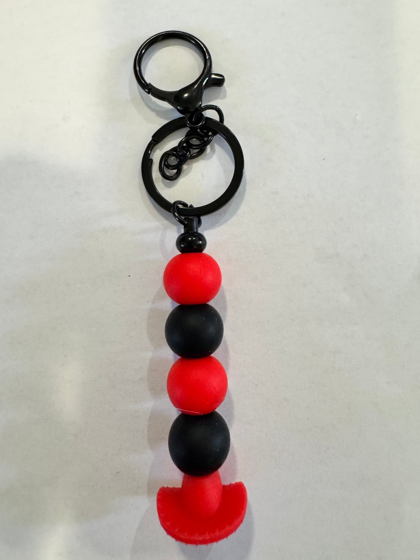 Keychain with red and black beads on a white background