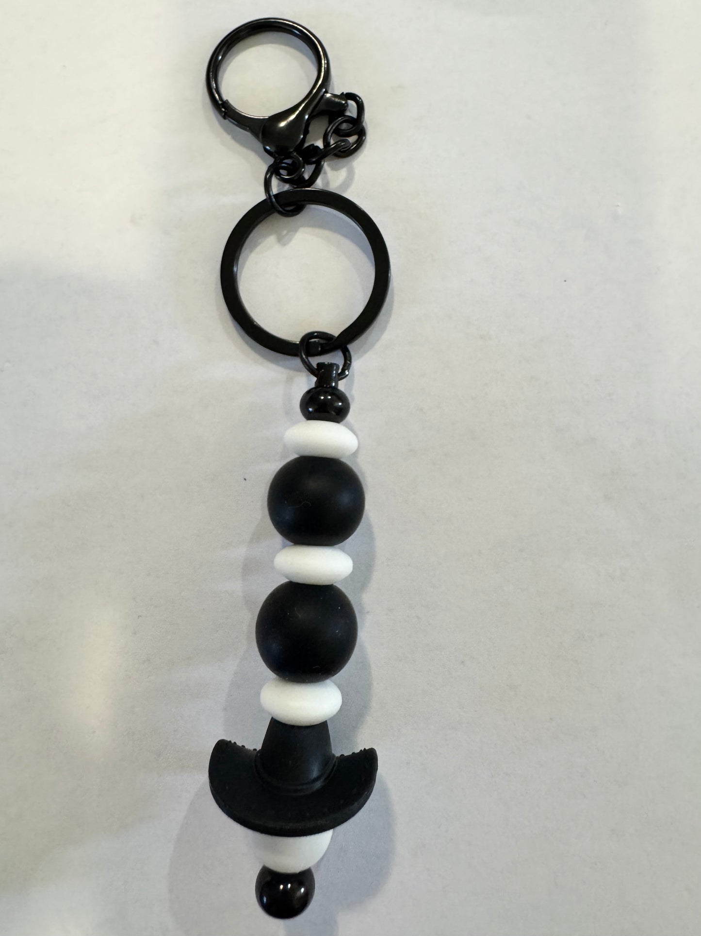 Black and white beaded keychain on a light gray background