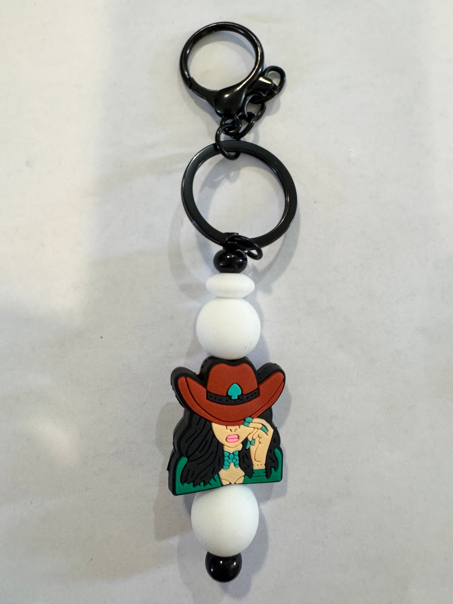 Keychain with a character wearing a red hat on a white background