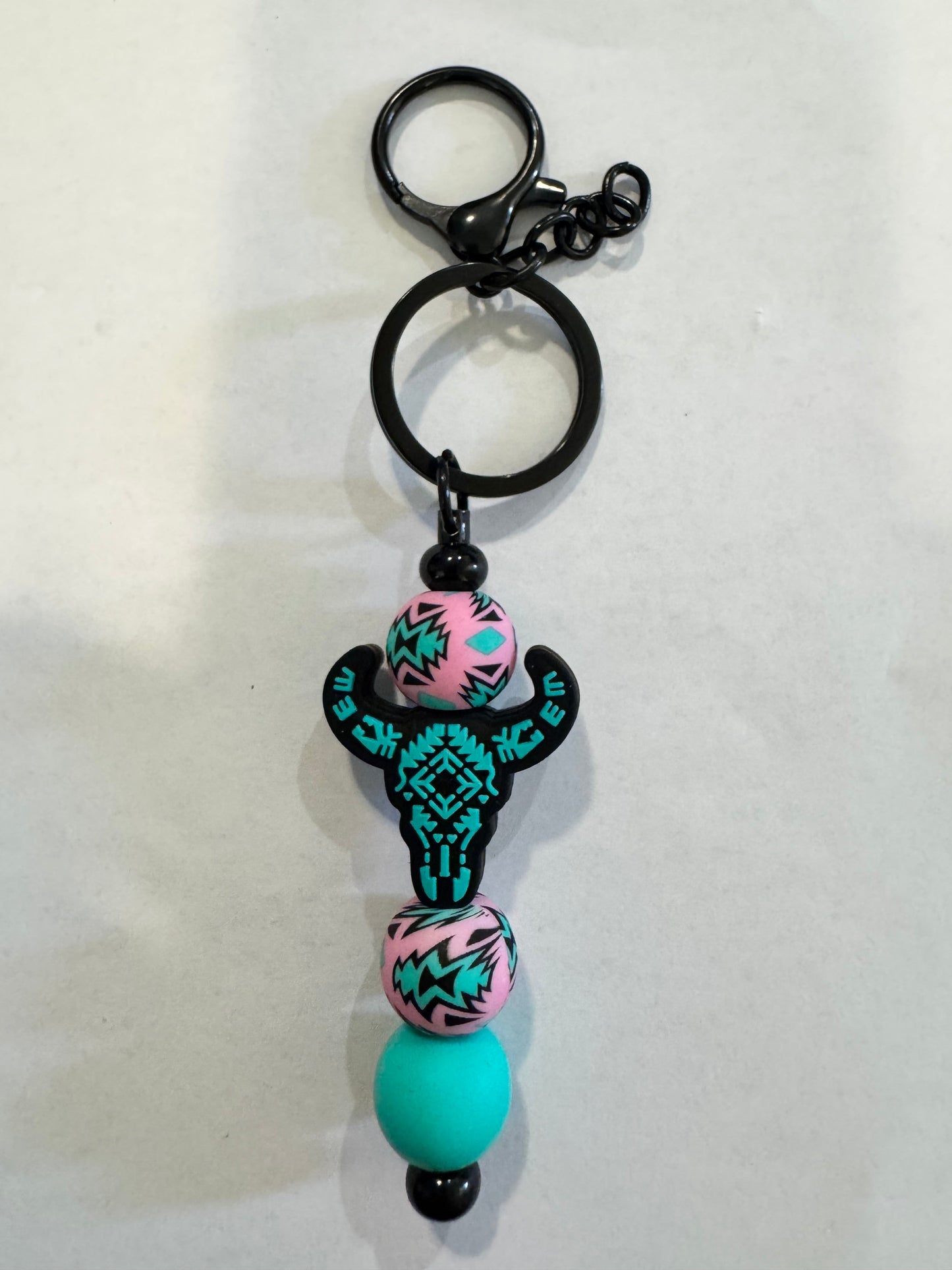 Keychain with colorful beads and a black clasp on a white background