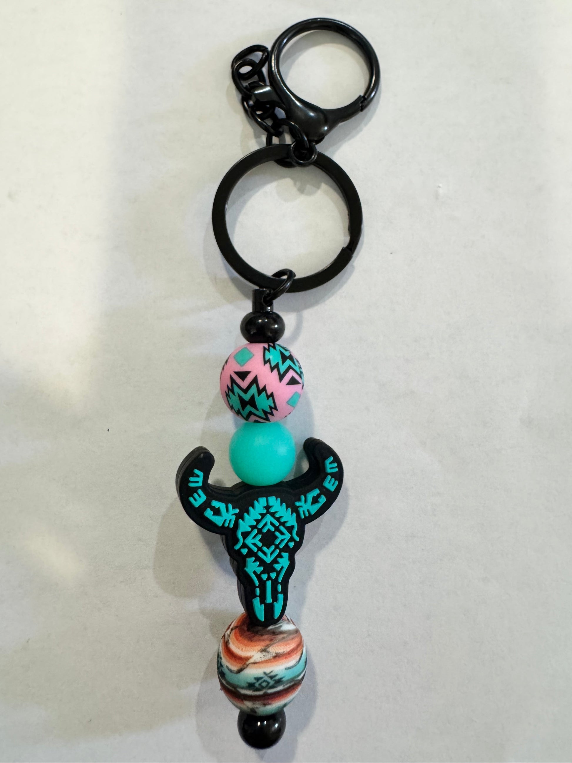 Keychain with colorful beads and a decorative element on a white background