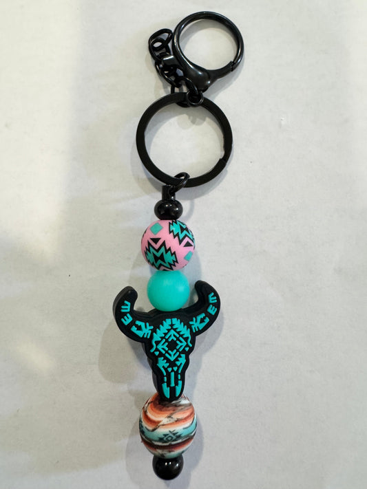 Keychain with colorful beads and a decorative element on a white background