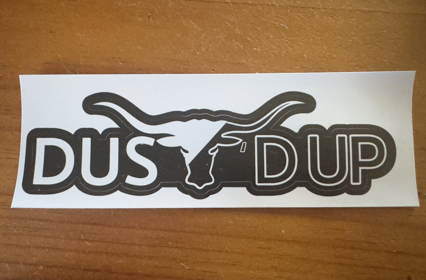 Sticker withDUSt'd uplogo on a white background