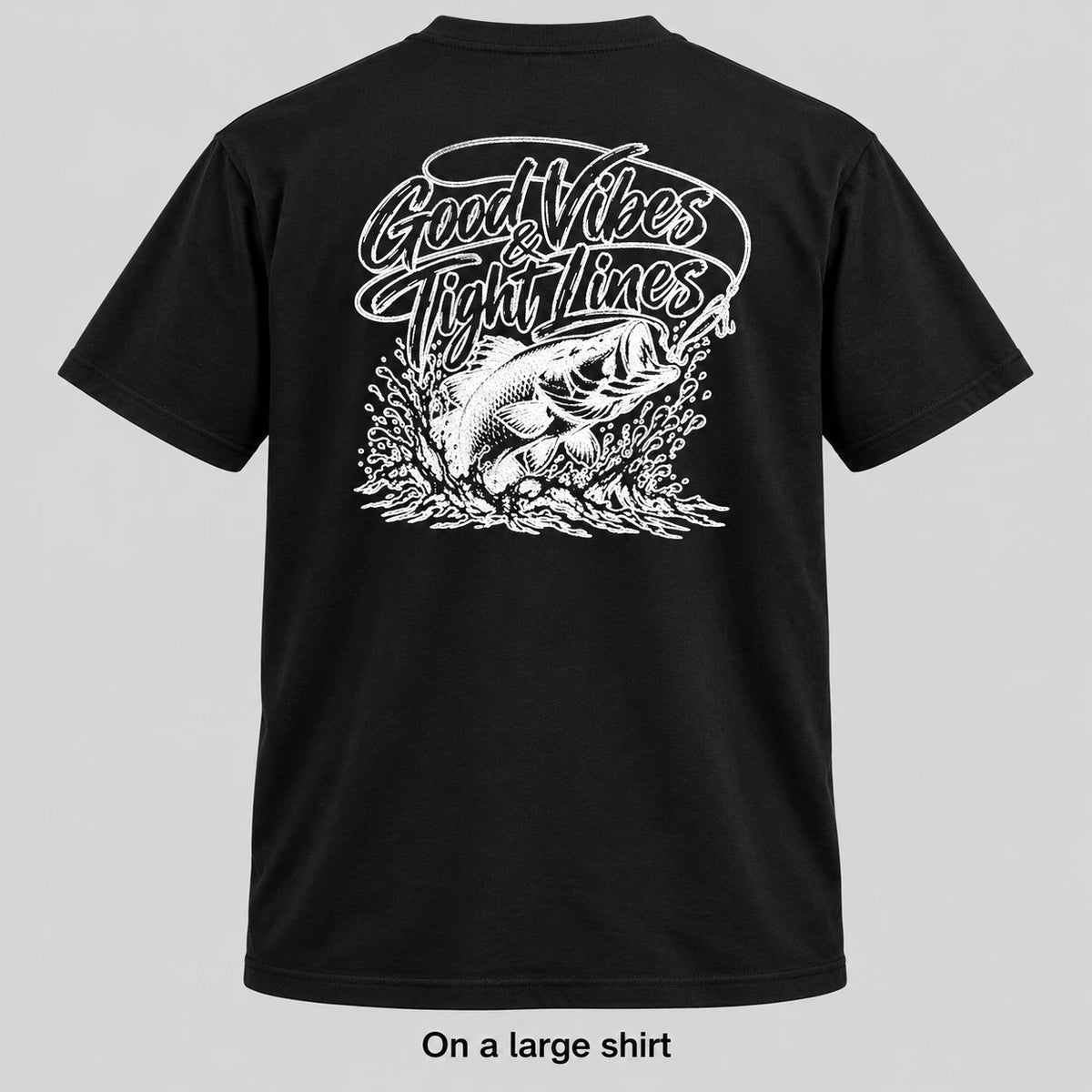 Black short-sleeve t-shirt shown from the back with a large white graphic of a fish and the text 'Good Vibes Fight Lines'. The image is presented on a light gray background with the text 'On a large shirt' below the product.