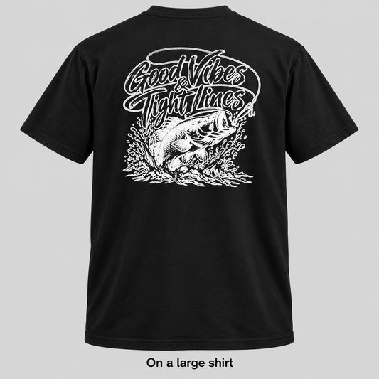 Black short-sleeve t-shirt shown from the back with a large white graphic of a fish and the text 'Good Vibes Fight Lines'. The image is presented on a light gray background with the text 'On a large shirt' below the product.
